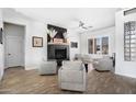 Bright living room featuring a fireplace, plank flooring, and four comfortable chairs at 9545 E Gary St, Mesa, AZ 85207