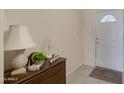 Charming entryway featuring tile floors, a decorative table, and a bright, white front door at 11360 E Keats Ave # 20, Mesa, AZ 85209