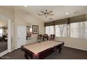 The game room has a pool table with a ceiling fan, and is brightly lit with natural light at 11375 E Sahuaro Dr # 2064, Scottsdale, AZ 85259