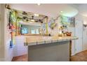 Entertainer's bar with large mirror, decorative lighting, tile floors, and generous counter space at 12434 S Ki Cir, Phoenix, AZ 85044