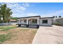 Inviting single-story home featuring a covered front porch and a spacious driveway at 1427 W 6Th Dr, Mesa, AZ 85202