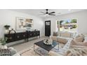 Bright living room features a comfortable sectional sofa, stylish decor, and a large window at 1535 W Berridge Ln, Phoenix, AZ 85015