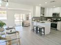 Open-concept living space flows seamlessly into a modern kitchen with an island and stainless steel appliances at 1561 N Sterling St, Mesa, AZ 85207