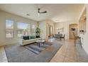 Open-concept living area with tile flooring, natural light, and a comfortable seating arrangement at 16420 N Thompson Peak Pkwy # 2101, Scottsdale, AZ 85260