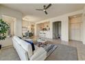 Spacious living room with a ceiling fan, comfortable seating, and a seamless flow to the kitchen at 16420 N Thompson Peak Pkwy # 2101, Scottsdale, AZ 85260