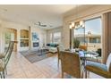 Bright living space featuring fireplace, tile flooring, and seamless indoor-outdoor flow at 16420 N Thompson Peak Pkwy # 2101, Scottsdale, AZ 85260