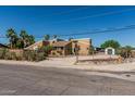 Home with neutral colors, desert landscaping, mature trees, and fenced yard at 1953 E Presidio Rd, Phoenix, AZ 85022