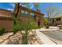 Charming two-story home with stucco exterior and stone accents, surrounded by mature landscaping at 19700 N 76Th St # 1040, Scottsdale, AZ 85255