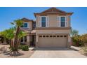 Charming two-story home with a well-maintained yard, two-car garage and mature palm tree at 1991 S Bahama Dr, Gilbert, AZ 85295