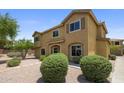 View of the two-story home featuring desert landscaping, exterior shutters, and beautiful shade trees at 21813 N 40Th Way, Phoenix, AZ 85050