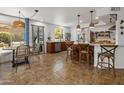 Spacious kitchen and dining area with tile flooring, stainless steel appliances, and a bright, airy feel at 21813 N 40Th Way, Phoenix, AZ 85050