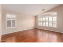 Bright bedroom with hardwood floors and plantation shutters on windows at 2230 E Whitten St, Chandler, AZ 85225