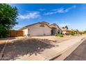 A single-story home with a three-car garage and desert landscaping for low maintenance at 2230 E Whitten St, Chandler, AZ 85225