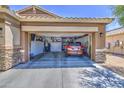 View of the open garage with a car parked inside with lots of storage space at 23781 W Mohave St, Buckeye, AZ 85326