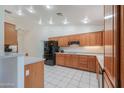 Bright kitchen featuring white tile floors, wood cabinetry, stainless appliances, and ample counter space at 238 W Myrna Ln, Tempe, AZ 85284