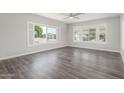 Bright living room featuring stylish wood flooring, large windows, and neutral wall color at 2650 W Union Hills Dr # 245, Phoenix, AZ 85027
