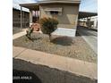 Charming home with well-maintained landscaping, desert plants, and covered parking at 300 S Val Vista Dr # 51, Mesa, AZ 85204