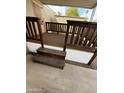 Covered patio area with dark wood railing and tan carpet at 300 S Val Vista Dr # 51, Mesa, AZ 85204