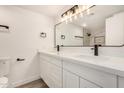 Bright bathroom with double sinks, white cabinets, and a large mirror with modern lighting at 308 W Oraibi Dr, Phoenix, AZ 85027