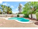 Backyard pool with a basketball hoop, dining table and fence at 3389 W Barcelona Dr, Chandler, AZ 85226