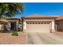 Tan single-story home with a neutral trim and a tan two-car garage at 3685 N 141St Dr, Goodyear, AZ 85395
