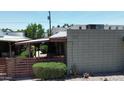 Exterior view of single-story home showing desert landscaping, block construction, and covered patio at 411 W Colter St # A, Phoenix, AZ 85013