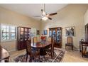 Traditional dining room has vaulted ceiling, patterned rug, and a table with chairs at 4136 E Greenway Cir, Mesa, AZ 85205