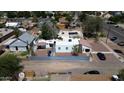 An aerial shot featuring a property with a red roof and neutral exterior, set within a bustling neighborhood at 42 E 2Nd Ave, Mesa, AZ 85210