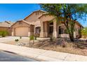 Charming single-story home with a two-car garage and desert landscaping at 42196 W Chisholm Dr, Maricopa, AZ 85138