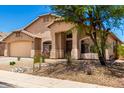 Charming single-story home with a two-car garage and desert landscaping at 42196 W Chisholm Dr, Maricopa, AZ 85138