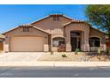 Charming single-story home with a two-car garage and desert landscaping at 42196 W Chisholm Dr, Maricopa, AZ 85138