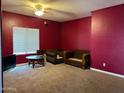 Cozy living room with coffee table, two armchairs, and a window at 43418 W Wild Horse Trl, Maricopa, AZ 85138