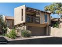 Beautiful townhome featuring neutral-colored stucco, an attached two-car garage, and a private, gated courtyard at 4434 E Camelback Rd # 132, Phoenix, AZ 85018