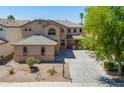 Beautiful two-story home with a well-manicured front yard and long driveway leading to a 3-car garage at 45113 W Buckhorn Trl, Maricopa, AZ 85139