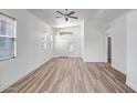 Spacious living room with wood floors, bright windows, and a modern ceiling fan at 5125 E Juana Ct, Cave Creek, AZ 85331