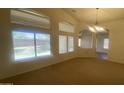 Bright living room featuring neutral colors, carpet flooring, and large windows at 5374 N Ormondo Way, Litchfield Park, AZ 85340