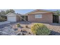 Low-maintenance desert landscaping and a tidy exterior define this charming single-story home at 5618 E Des Moines St, Mesa, AZ 85205