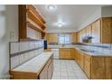 Spacious kitchen with ample cabinet space and tiled countertops at 5618 E Des Moines St, Mesa, AZ 85205
