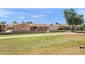 Expansive backyard with green space, walkway, and block fence, perfect for relaxing or entertaining guests at 636 S Rosemont --, Mesa, AZ 85206