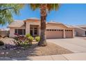 Well-kept single-story home with a three-car garage and desert landscaping at 7345 E Forge Ave, Mesa, AZ 85208
