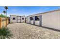 Outdoor shed offers lots of extra storage space with desert landscaping and a fenced area to protect your privacy at 7711 E Farmdale Ave, Mesa, AZ 85208