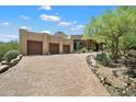 Stunning desert home boasts a private drive, three-car garage and landscaped front yard at 7731 E Soaring Eagle Way, Scottsdale, AZ 85266
