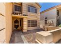 Welcoming front entrance with tiled porch and well-maintained landscaping at 82 N 221St Ave, Buckeye, AZ 85326