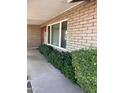 Inviting front porch with brick accents, mature landscaping, and a charming wooden door at 8355 E Via De Encanto --, Scottsdale, AZ 85258