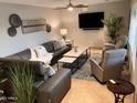 Spacious living room with a modern gray sofa, stylish decor, and tile flooring at 8355 E Via De Encanto --, Scottsdale, AZ 85258