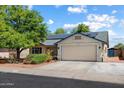 Charming single-story home featuring a two-car garage, solar panels, and well-maintained landscaping at 8540 W Ocotillo Rd, Glendale, AZ 85305
