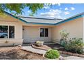 Inviting front entrance with desert landscaping, a security door, and decorative planters at 8540 W Ocotillo Rd, Glendale, AZ 85305