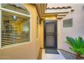 Inviting entrance with stylish black door and desert-friendly greenery at 8653 E Royal Palm Rd # 1030, Scottsdale, AZ 85258