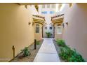 Attractive building entrance with desert landscaping and stucco walls at 8653 E Royal Palm Rd # 1030, Scottsdale, AZ 85258
