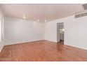 Spacious living room with hardwood floors, neutral paint, and ample natural light from window at 8738 E Vista Dr, Scottsdale, AZ 85250